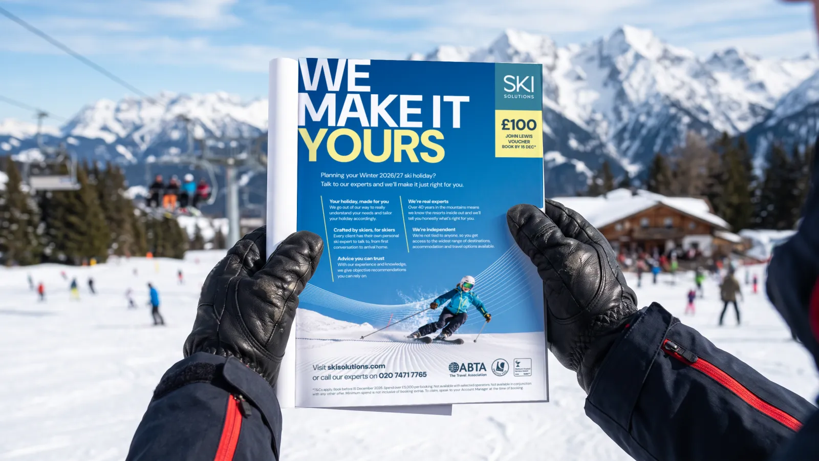 The Ski Solutions We Make It Yours City Christmas Fair advert held in a pair of ski gloves on the slopes, with a chairlift and mountains behind, in a portfolio visualisation.